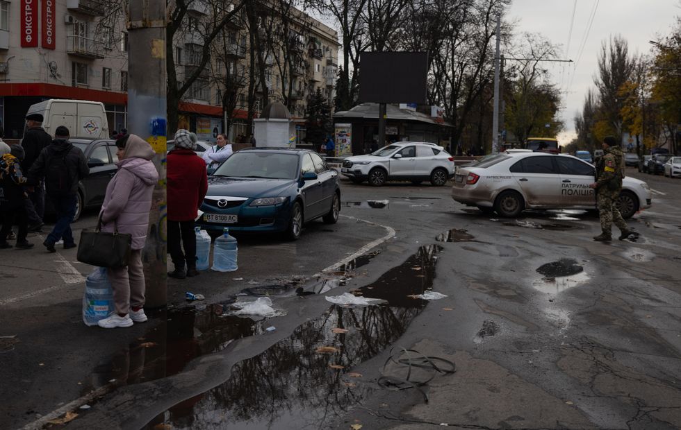 Residents stand in lines for humanitarian aid in Kherson after its liberation