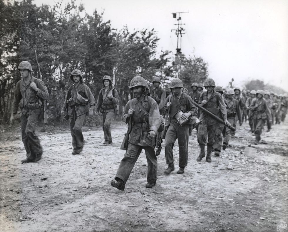 Returning from the Front Lines, 1944. "Marines of the Second Regiment, Second Division, come off the front lines after twenty days of slugging it out with, and defeating the Japs in their assigned sector of the battle of Saipan, which included the town of Garapan.