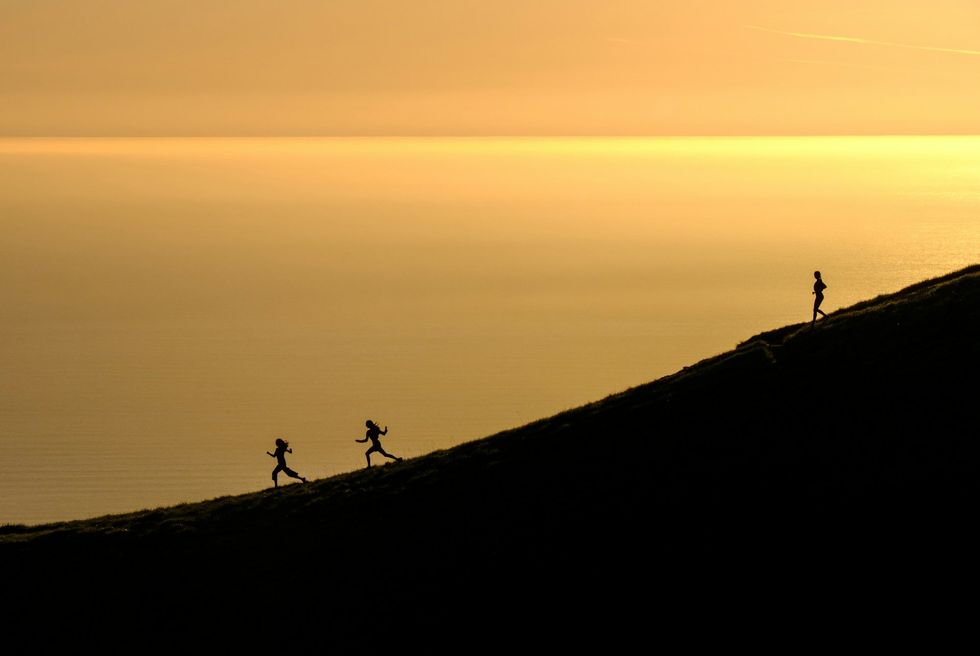 running on hillside in front of the coast