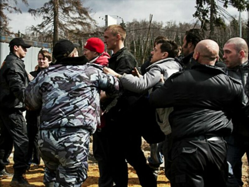 Russian environmentalists trying to break through a cordon of security guards