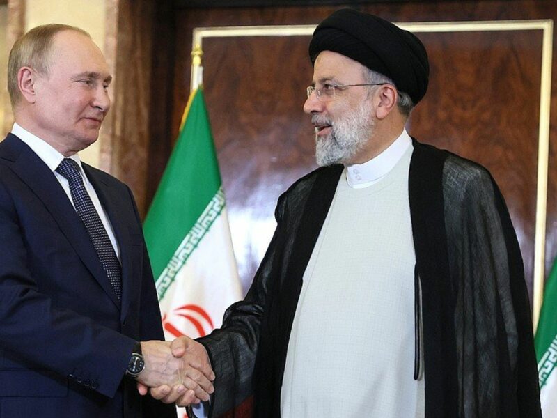Russian President Vladimir Putin shakes hands with President of Iran Sayyid Ebrahim Raisi