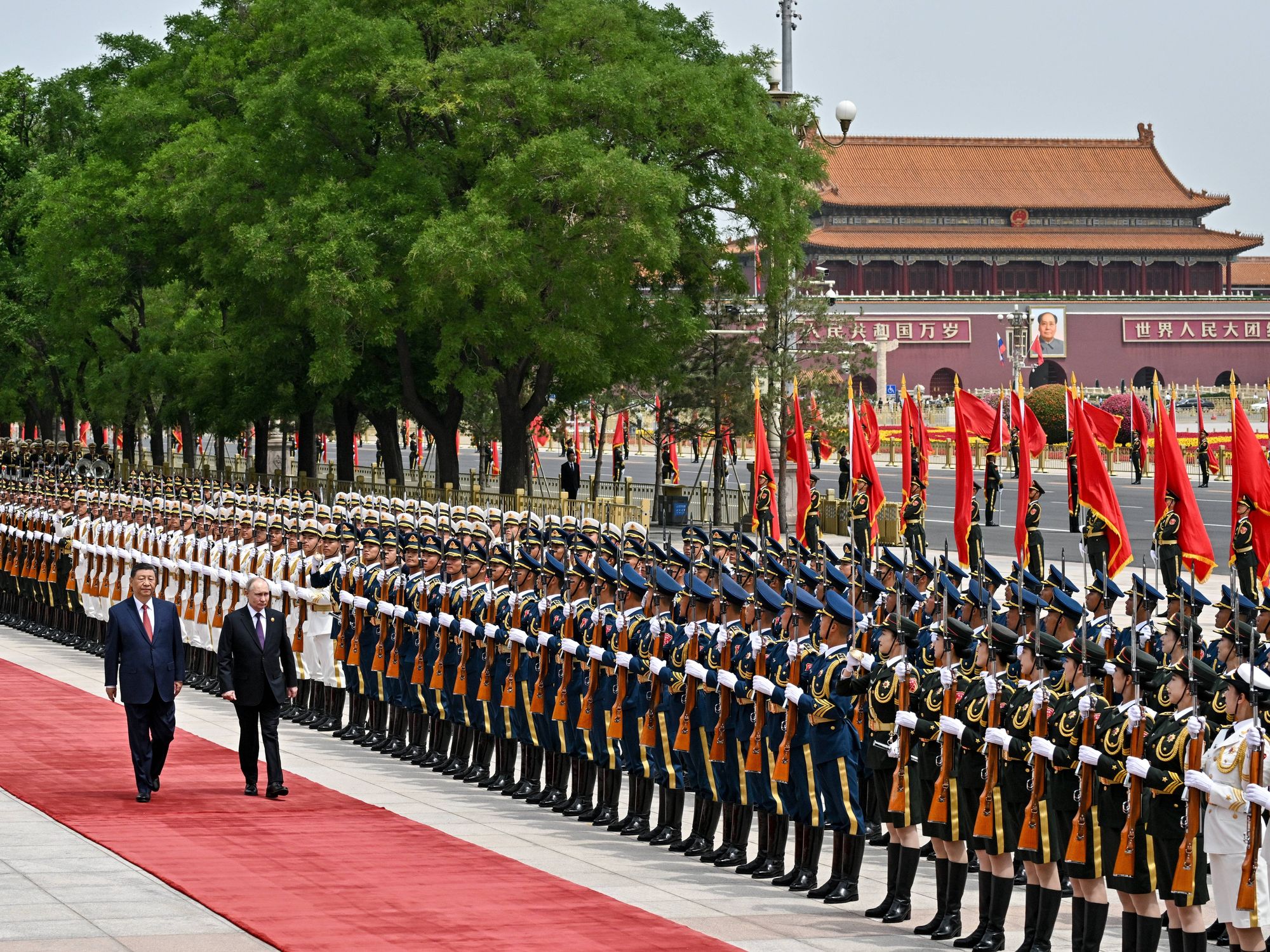 Russia's President Vladimir Putin and China's President Xi Jinping attend an official welcoming ceremony in front of the Great Hall of the People in Tiananmen Square.