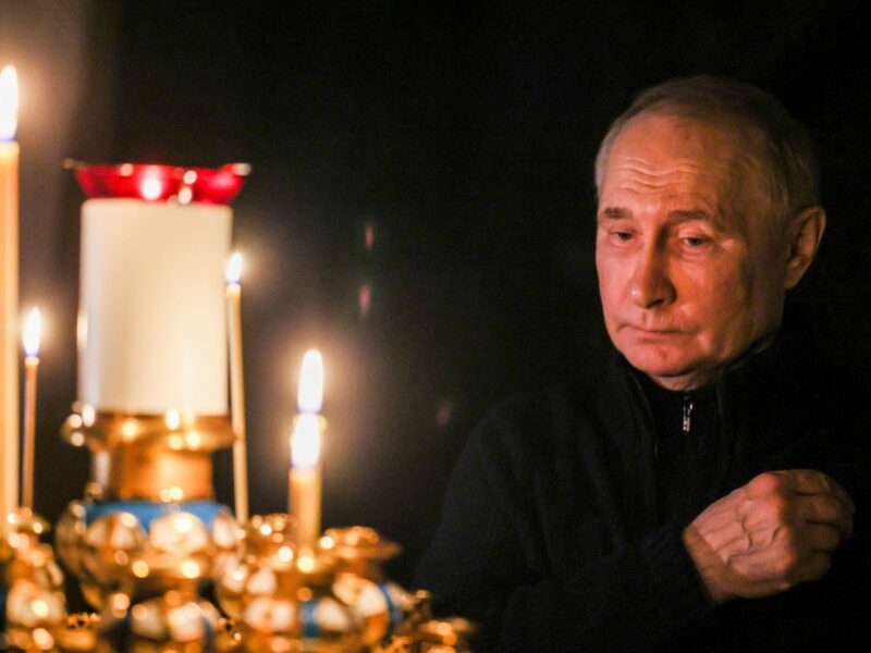 Russia's President Vladimir Putin lights a candle to commemorate victims of a terrorist attack on the Crocus City Hall.