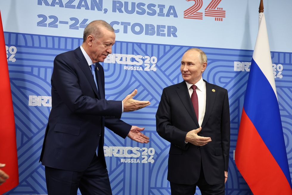 Russia's President Vladimir Putin (R) and Turkey's President Recep Tayyip Erdogan meet on the sidelines of the 2024 BRICS Summit at the Kazan Expo International Exhibition Centre in Bolshiye Kabany, Republic of Tatarstan, Russia on October 23, 2024