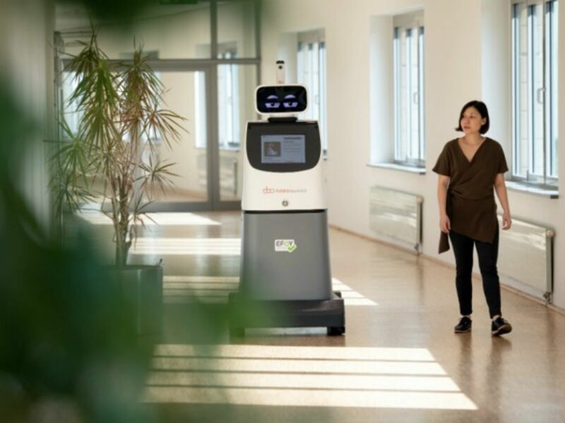 Sara Pereira passes the security robot ''Roboguard'' at a press conference for a security fair, on Sept. 20.