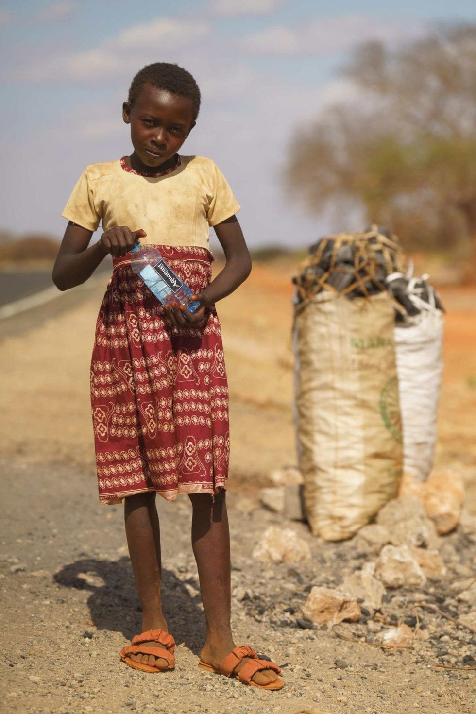 Sarah John sells charcoal on the A3 highway west of Garissa County.
