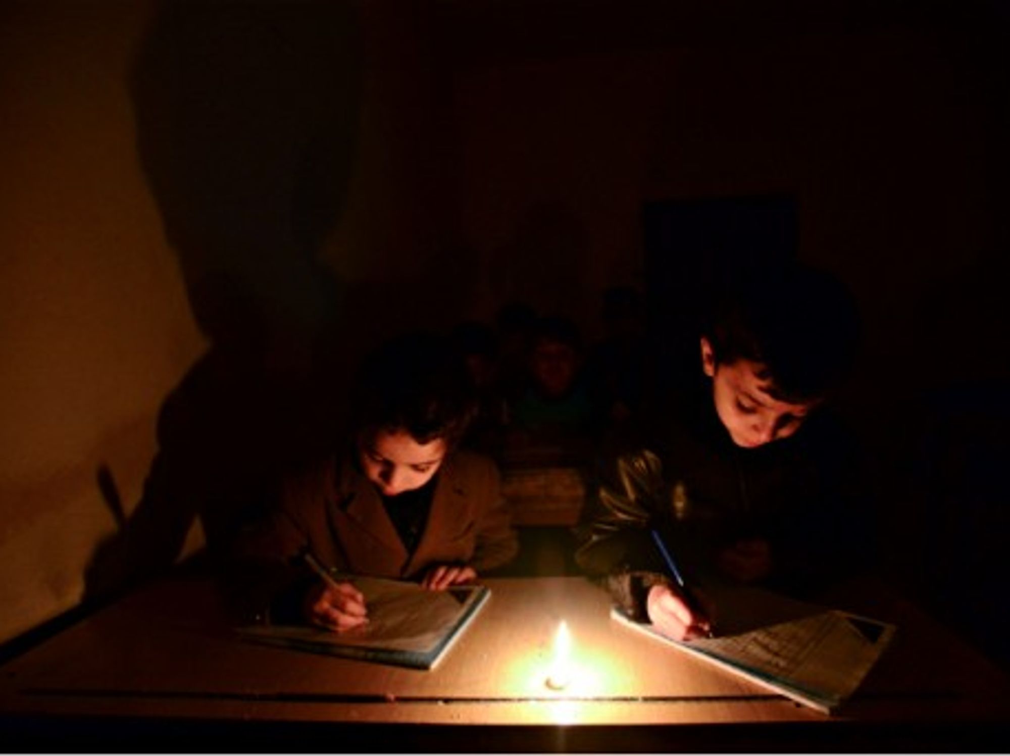 Schoolchildren studying without electricity in Aleppo, Syria