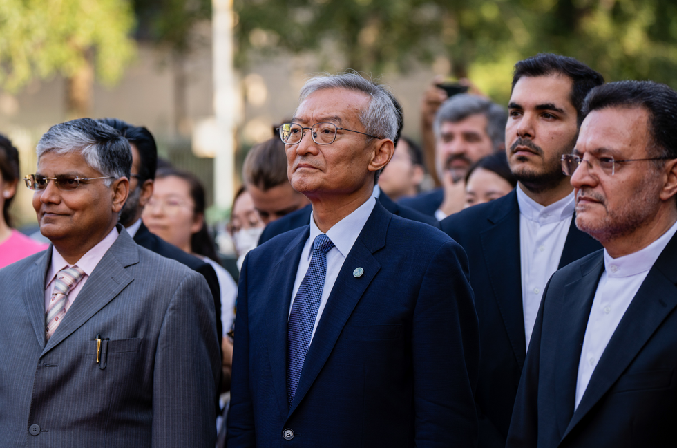 SCO Secretary General Zhang Ming (C) and Iran's Ambassador to China Mohsen Bakhtiyar (R) attend a ceremony to raise the flag of Iran at the Secretariat of the Shanghai Cooperation Organization.