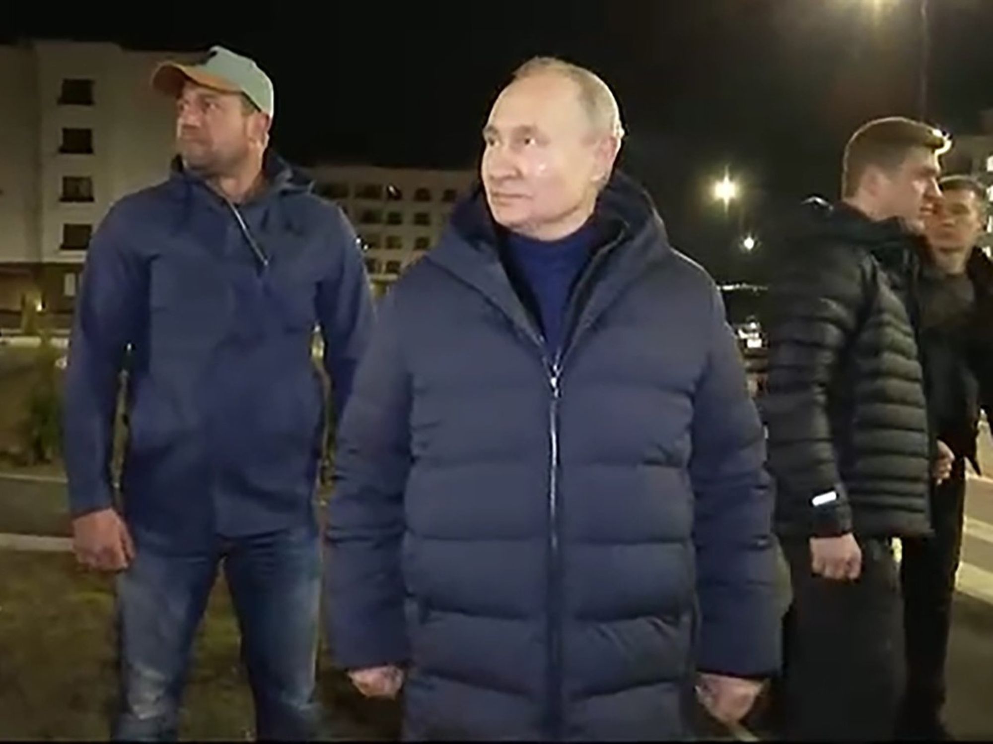 screen grab of Putin in a dark down jacket