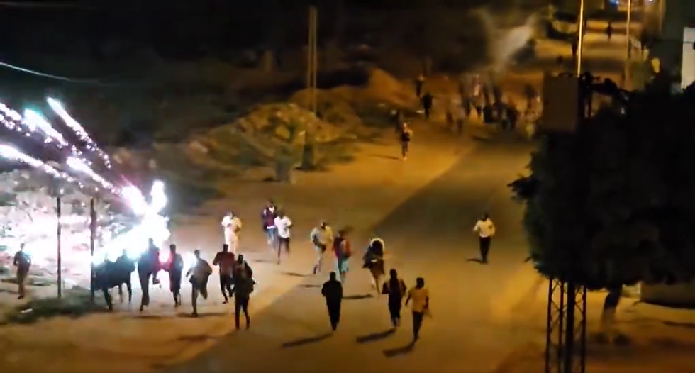 Screenshot of a video of migrants running away from a firework mortar attack in Sfax