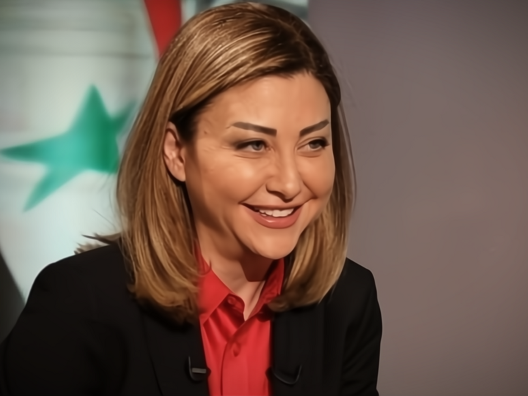 Screenshot of a YouTube video showing a smiling Luna al-Shibl, media advisor to Syrian President Bashar al-Assad