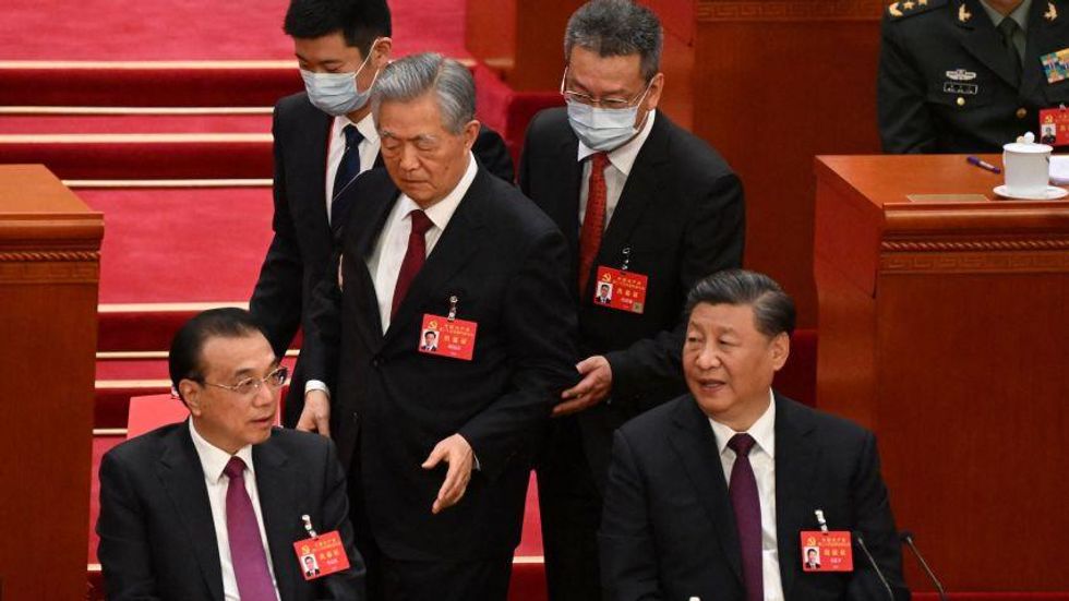 Screenshot of Hu Jintao being removed from his seat at the closing ceremony of the Congress.