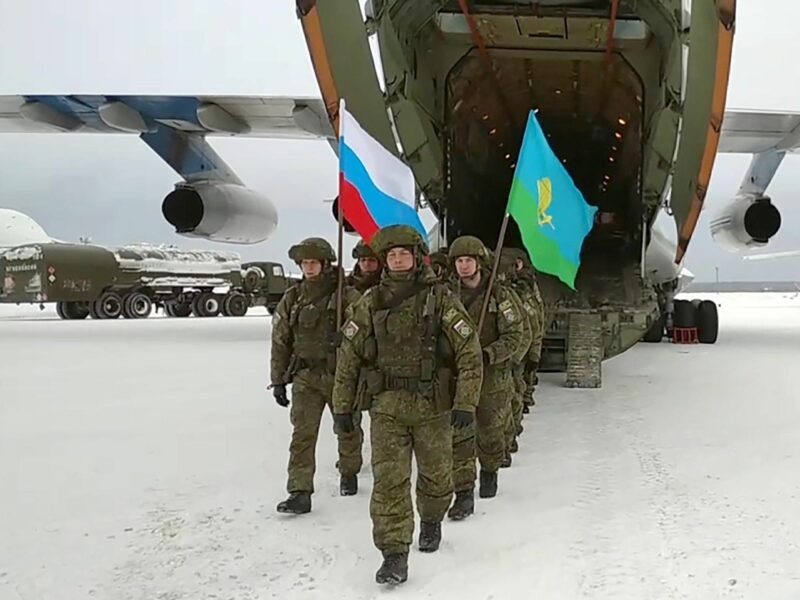 screenshot of russian soldiers holding russian and kazakh flags