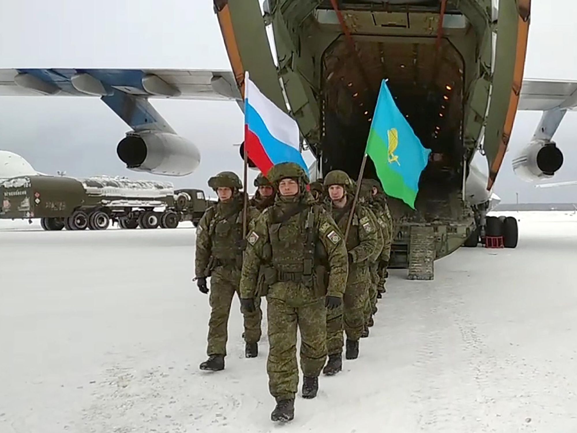 screenshot of russian soldiers holding russian and kazakh flags