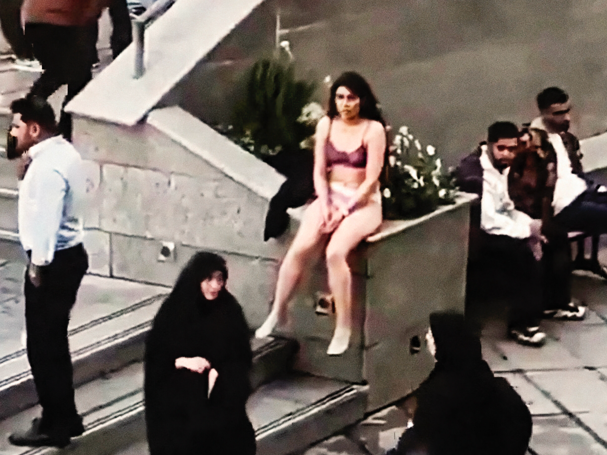 Screenshot of the footage showing a young Iranian woman's protest at a Tehran university