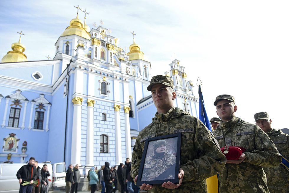 Servicemen carry the photograph and decoration of the late Serhii Ikonnikov, the youngest unit commander of the 72nd Black Zaporozhian Mechanized Brigade who died at the age of 25.