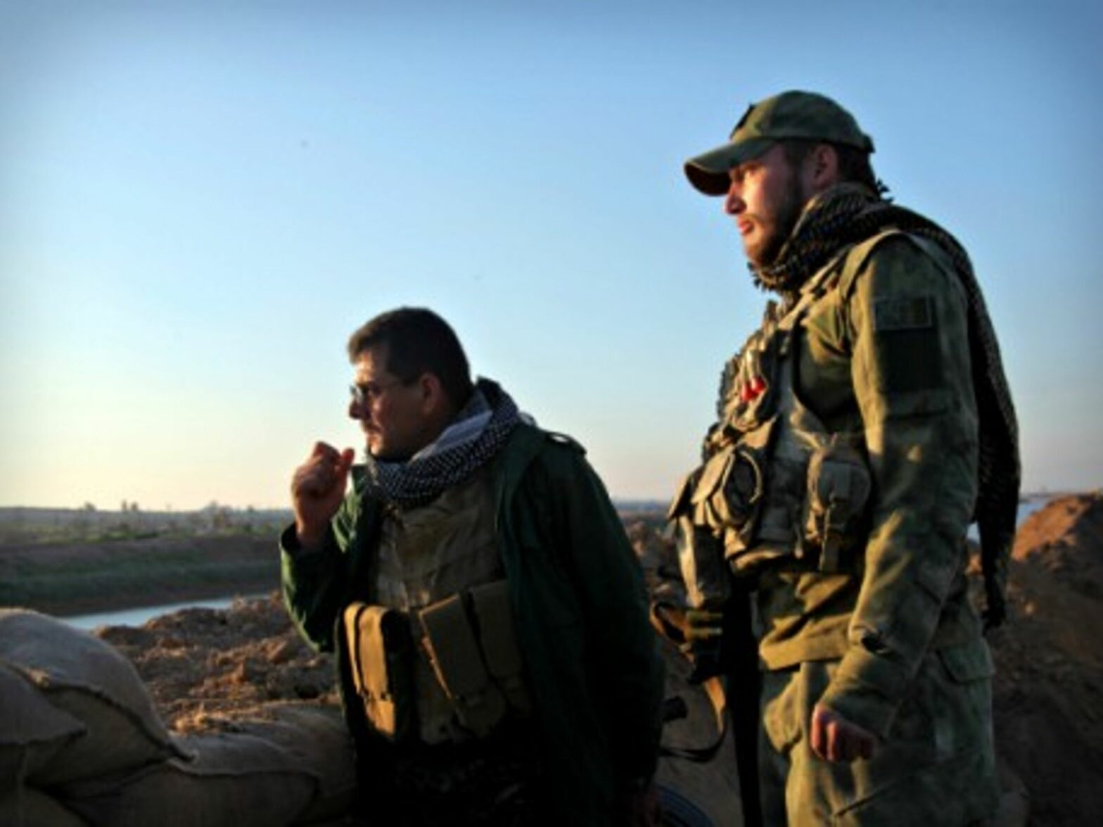 Shia soldiers look over an ISIS-controlled area near Kirkuk, Iraq