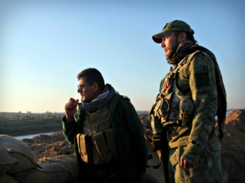 Shia soldiers look over an ISIS-controlled area near Kirkuk, Iraq