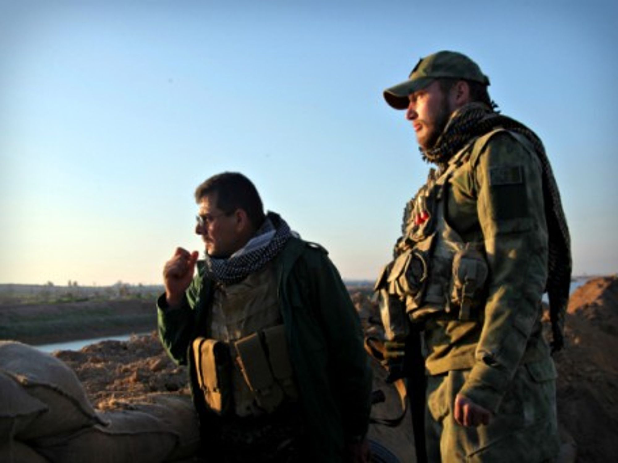 Shia soldiers look over an ISIS-controlled area near Kirkuk, Iraq