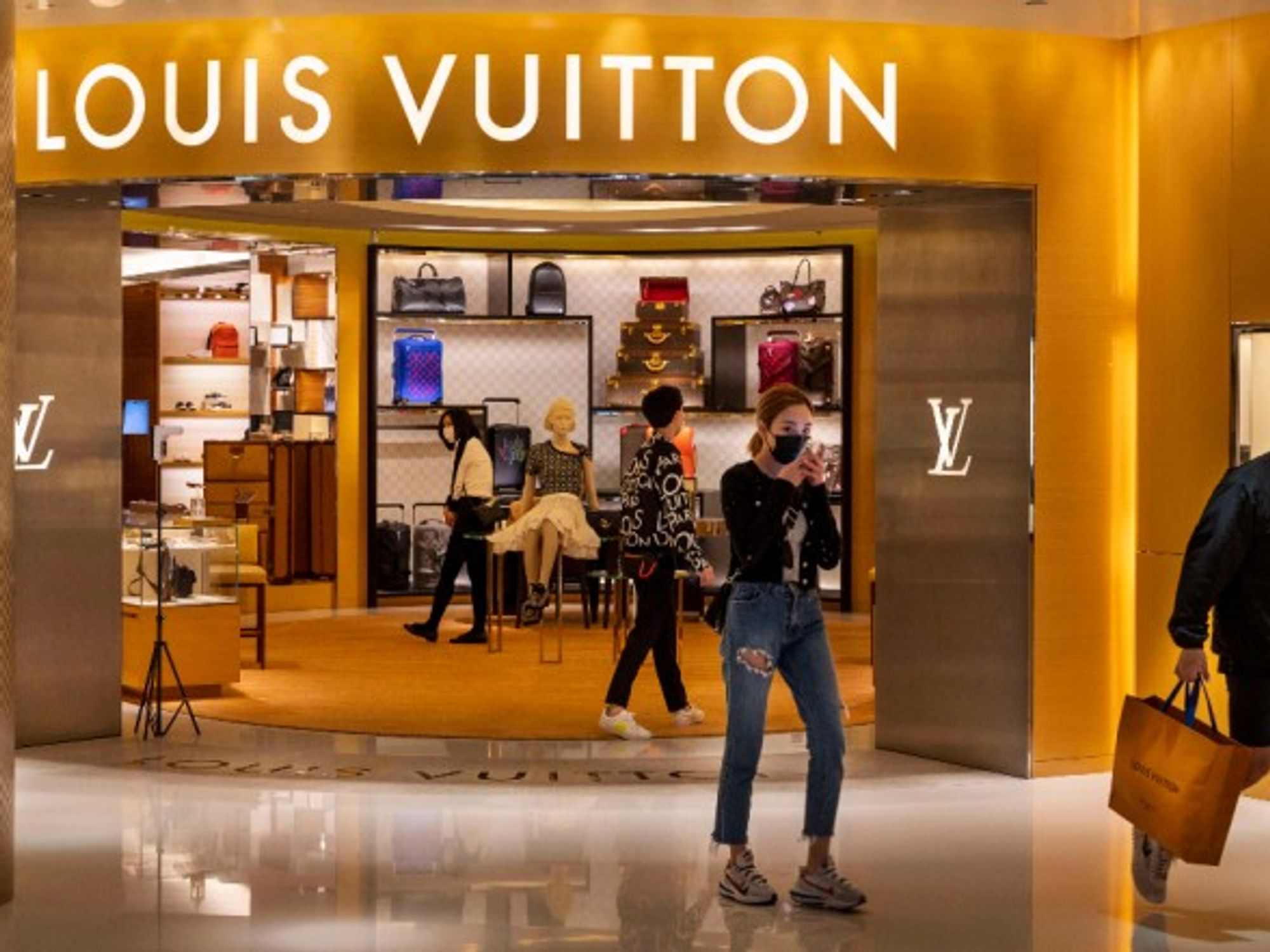 Shoppers at a French luxury fashion brand Louis Vuitton store