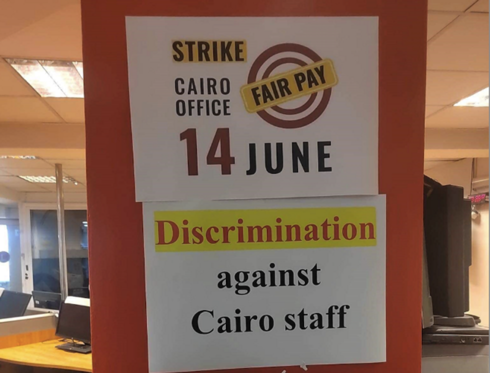 Sign with "Strike Cairo office, 14 June, Fair pay and discrimination against Cairo staff".