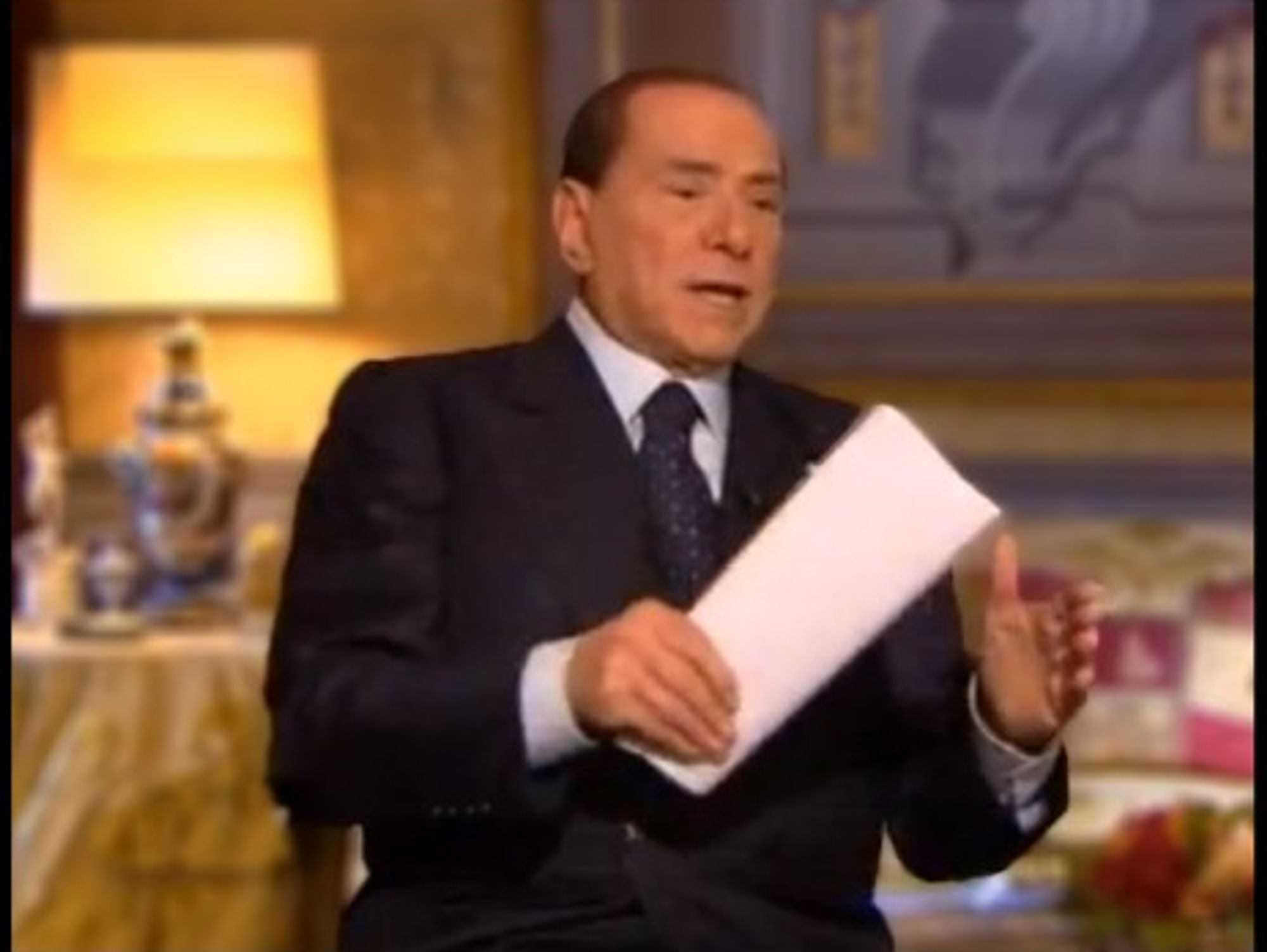Silvio Berlusconi carries his list of promises with him on TV