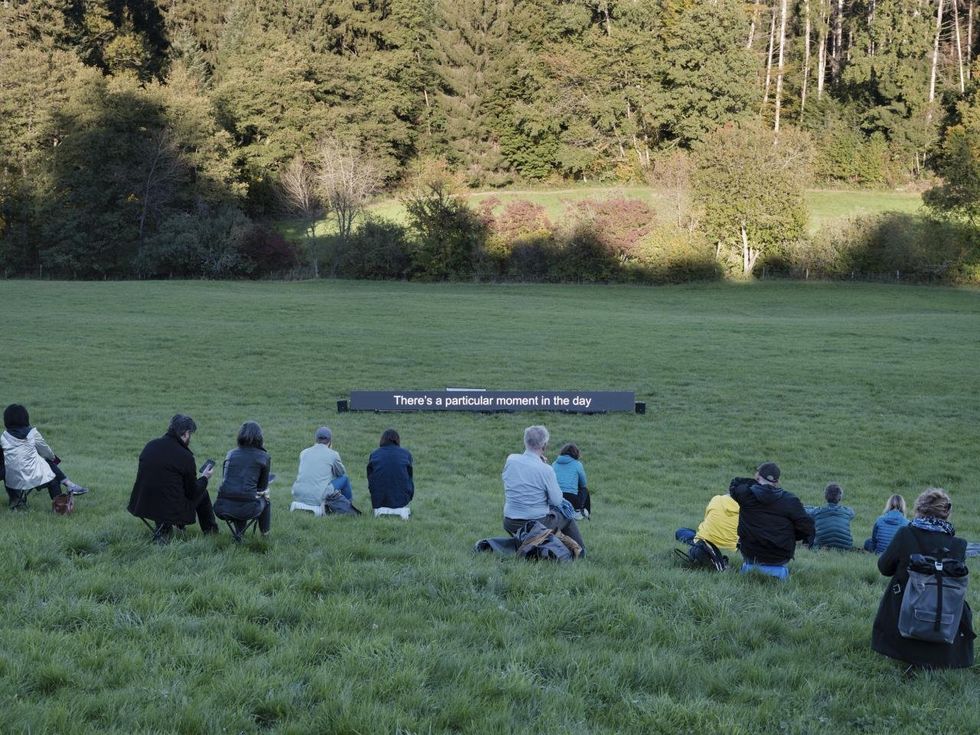 Sitting together in a lush meadow, participants reflect on their connection to nature at ‘Shared Landscapes.