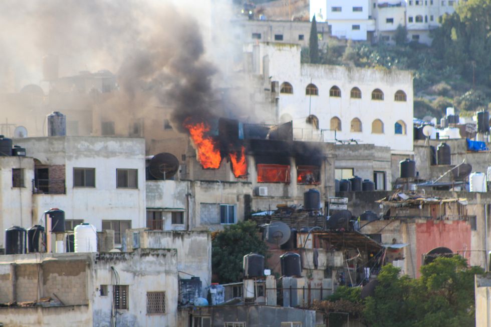 Smoke rises from a Palestinian house in the Jenin refugee camp after it was targeted by the Israeli army.