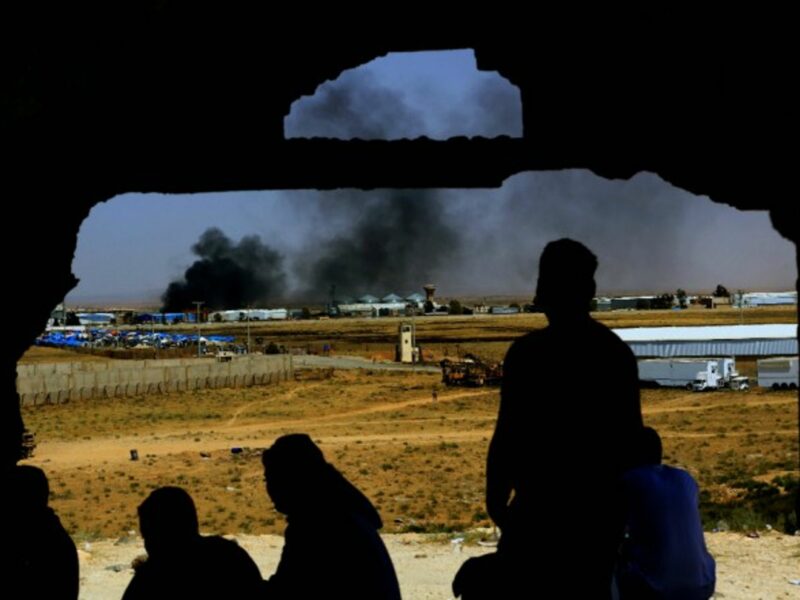 Smoke rises from the Syrian side at the Nasib Border Crossing between Jordan and Syria.