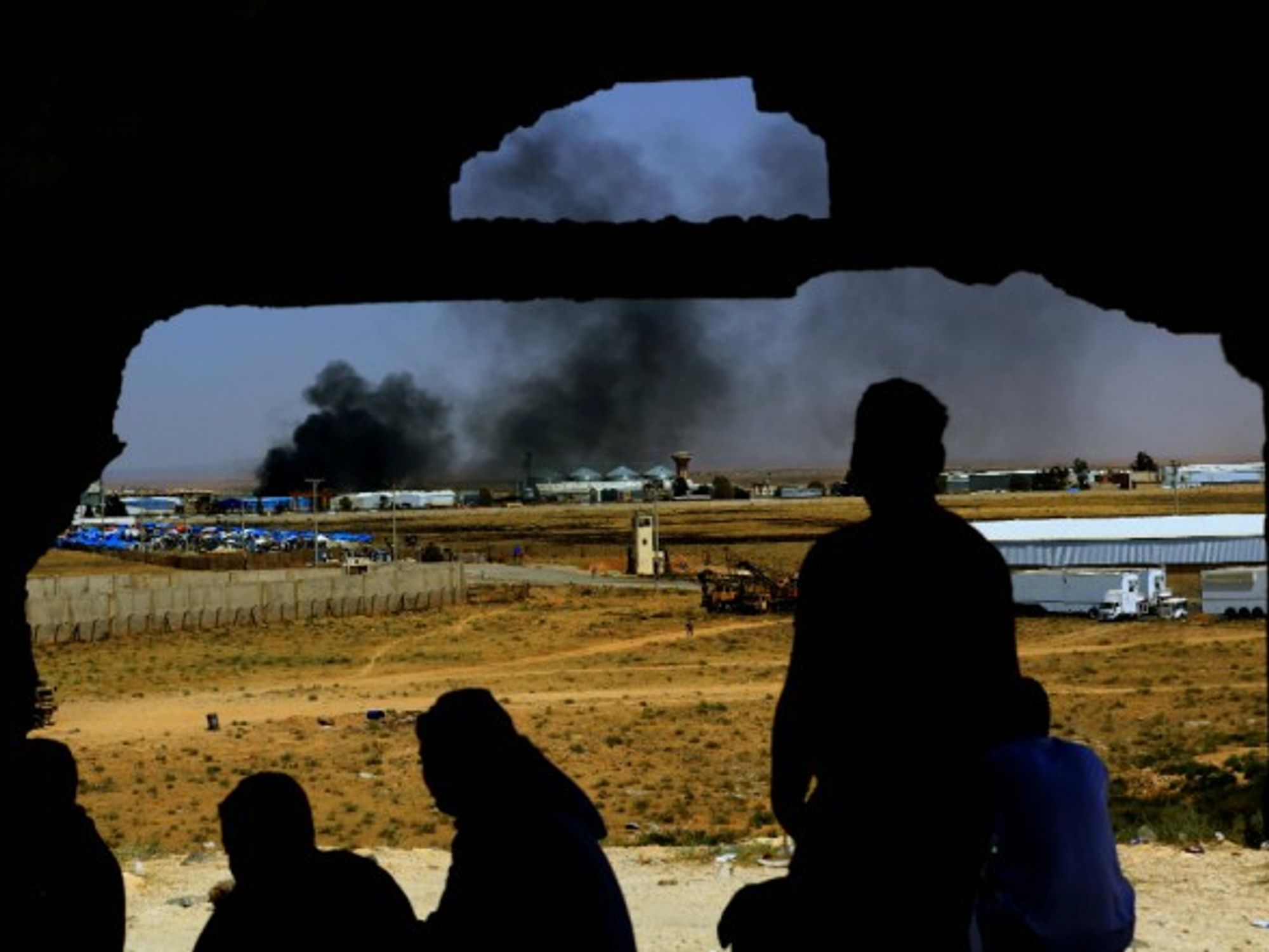 Smoke rises from the Syrian side at the Nasib Border Crossing between Jordan and Syria.