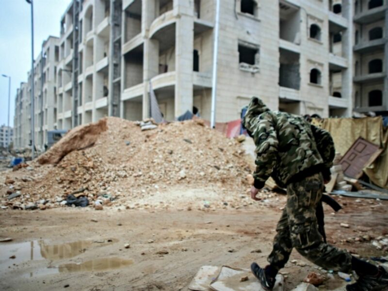 Soldier running in Bustan al-Qasr, Aleppo