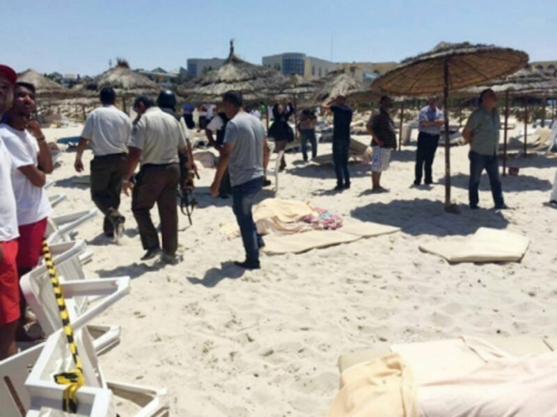 Soldiers and onlookers at the site of the attack in Sousse