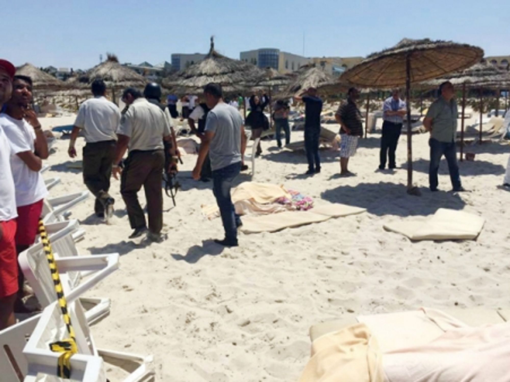 Soldiers and onlookers at the site of the attack in Sousse