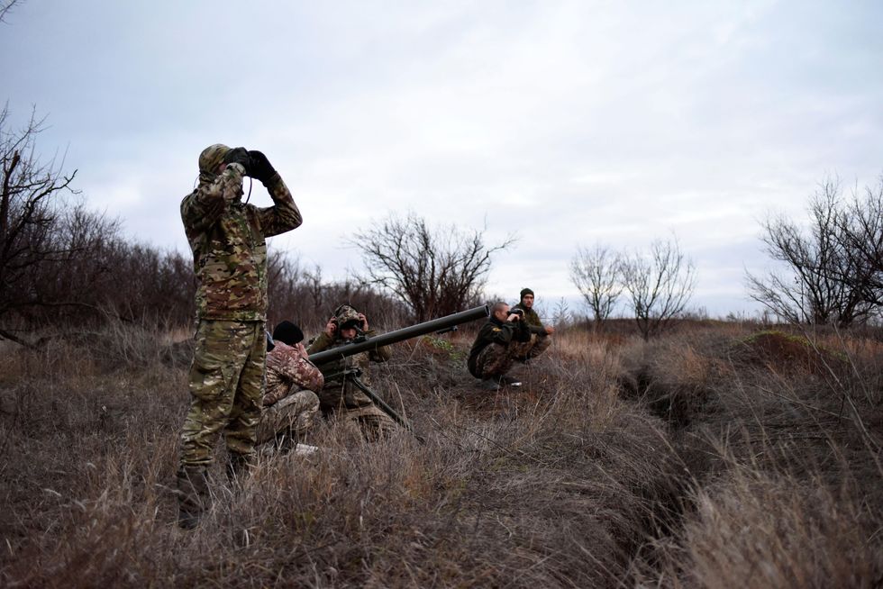 Soldiers of the 46th Separate Task Force Battalion Donbas-Ukraine surveying the territory.