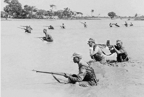 Soldiers wading through water