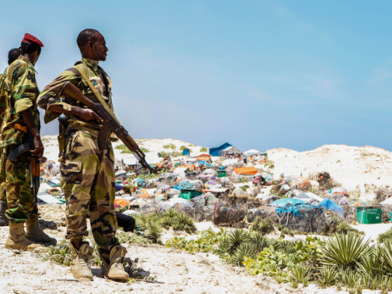 Soldiers watch over a Mogadishu slum