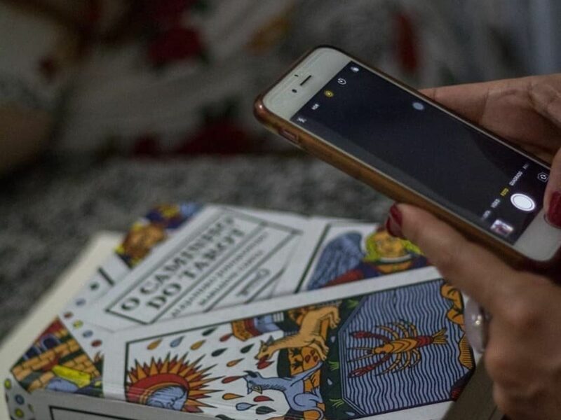 Someone taking a picture of tarot cards.