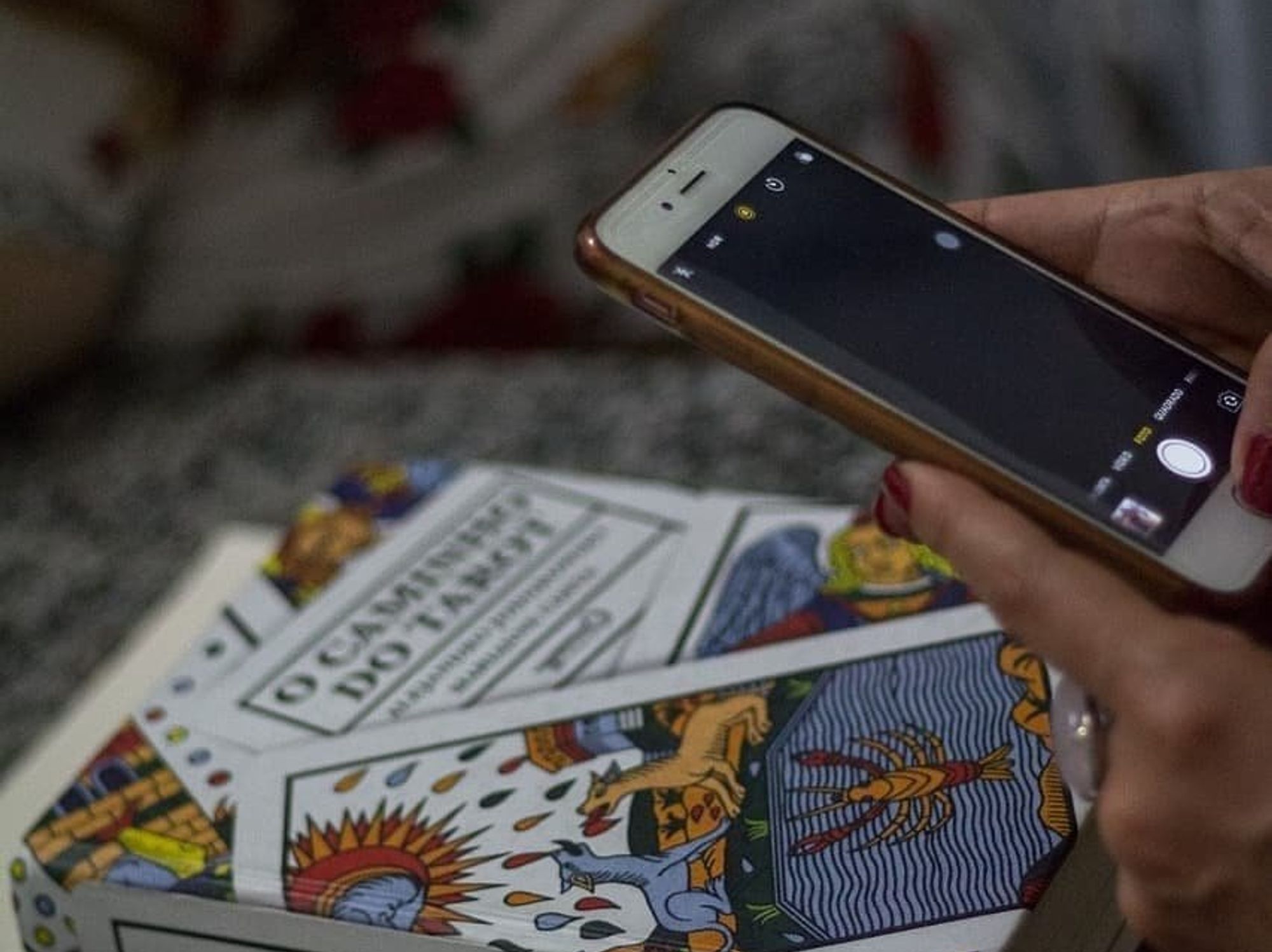 Someone taking a picture of tarot cards.