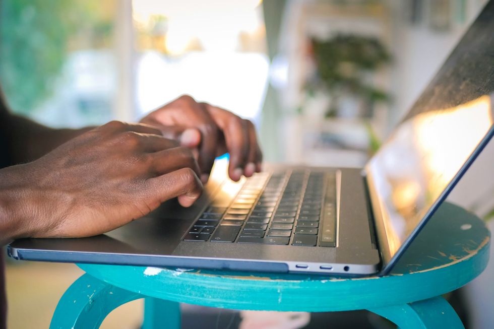 Someone working on a laptop.
