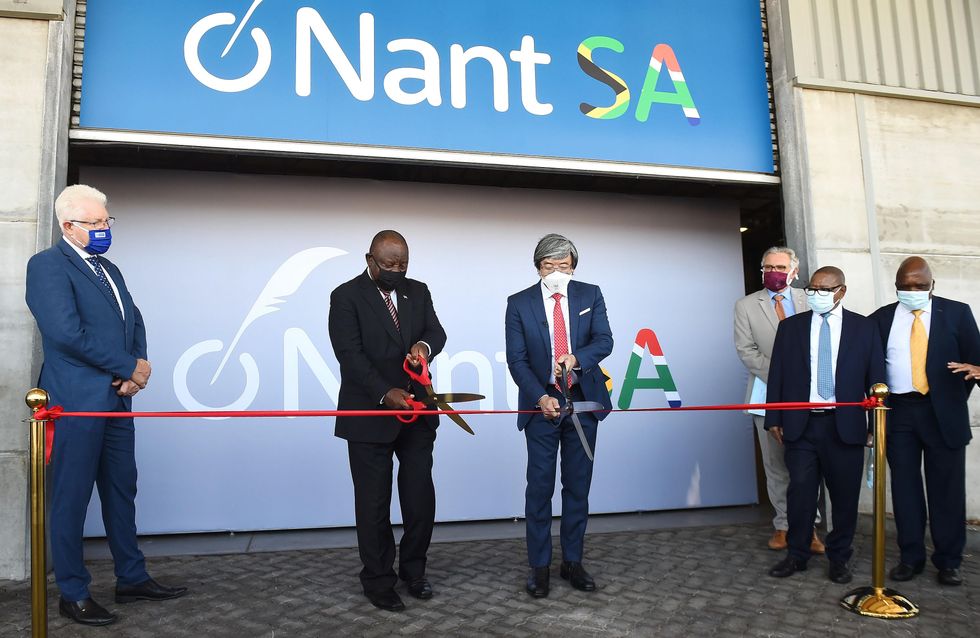 South African President Cyril Ramaphosa (2nd L) and biotech billionaire Patrick Soon-Shiong (3rd L) cut the ribbon during the launch of a vaccine manufacturing campus in Cape Town, legislative capital of South Africa, on Jan. 19, 2022