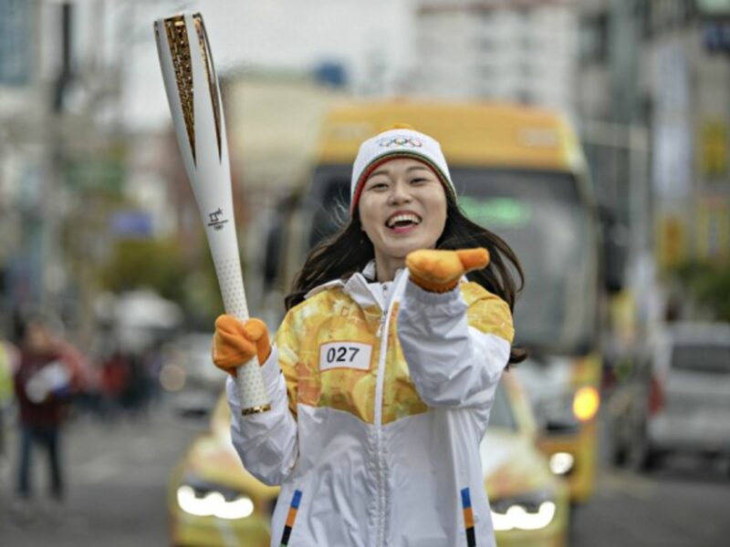 South Korean runner carrying the Olympic torch in Tongyeong