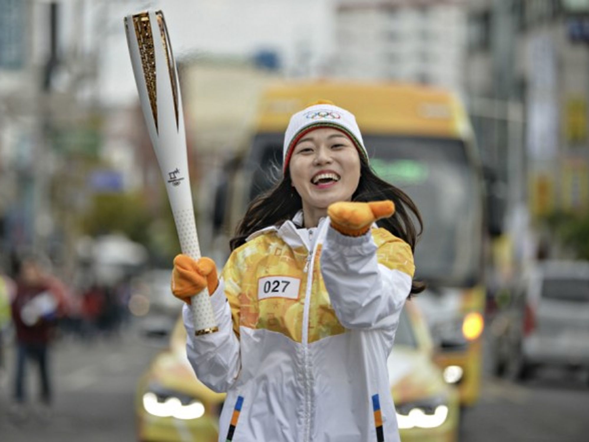 South Korean runner carrying the Olympic torch in Tongyeong