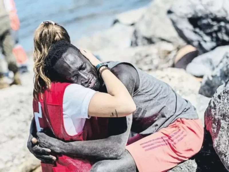Spanish Red Cross volunteer Luna Reyes embraces an illegal migrant on the shores of the Spanish enclave of Ceuta, off the Moroccan coast. May 2021
