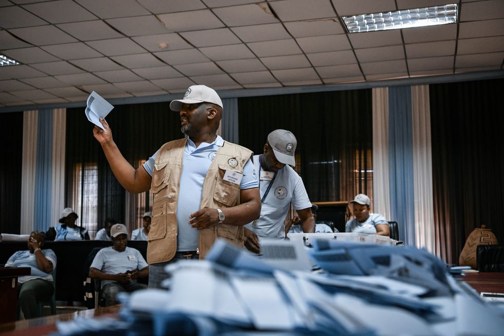 Staff members count ballots at a polling station in Tlokweng, South-East district, Botswana, Oct. 31, 2024.