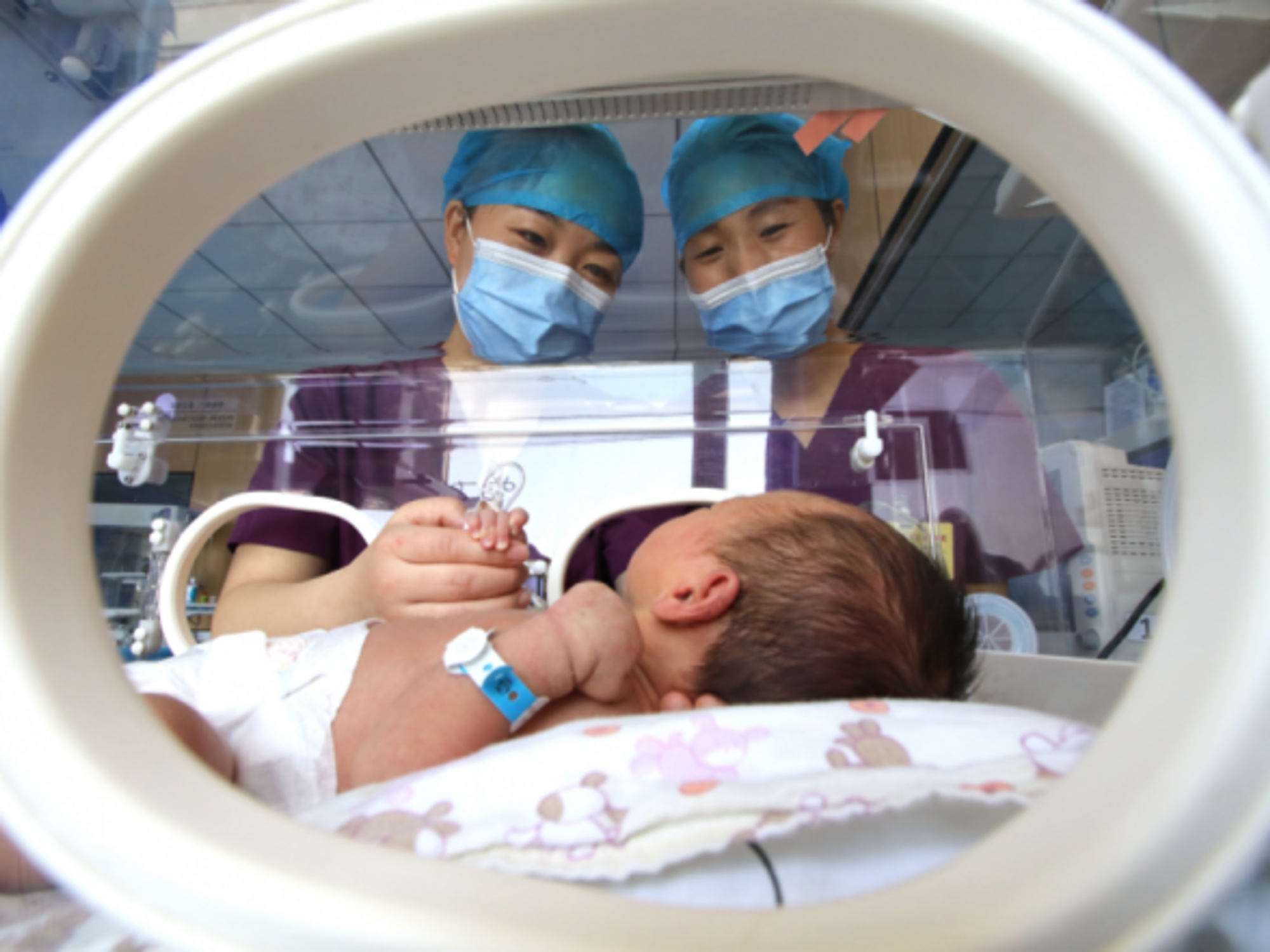 Staff watching over a newborn at a hospital in Handan, China, on May 10