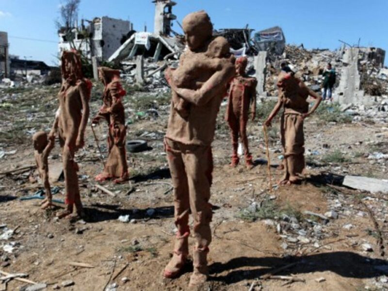 Statues by Palestinian artist Eyad Sabbah, in the rubble of buildings destroyed in last summer's conflict