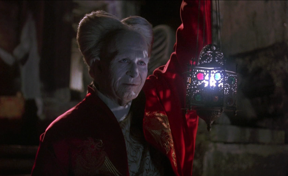 Still of Gary Oldman as Dracula in Coppola's 1922 film Bram Stoker's Dracula. He holds a lamp, showing his century old face.