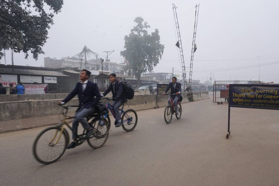Students cross the border between Nepal and India near Banke.