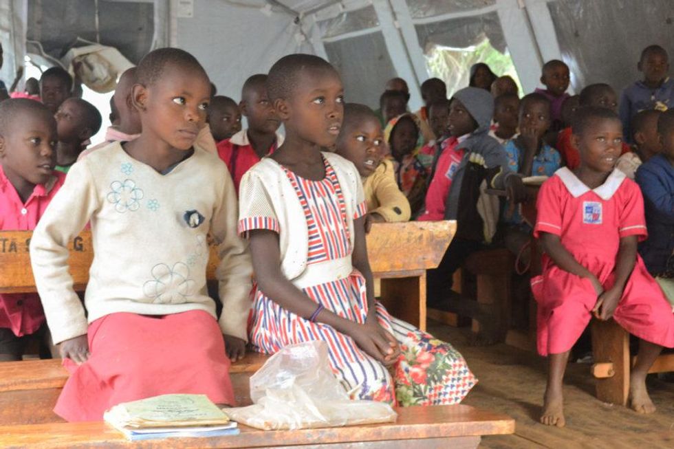 Students of Kyeihara Integrated Primary School attend class in a makeshift tent in Sheema. Two years of closures to control the coronavirus pandemic left unattended school buildings severely damaged.