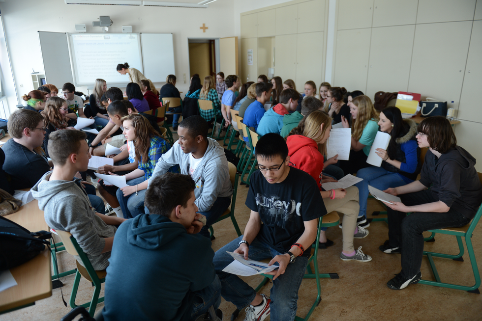Students take part in a group exercise in a German classroom.